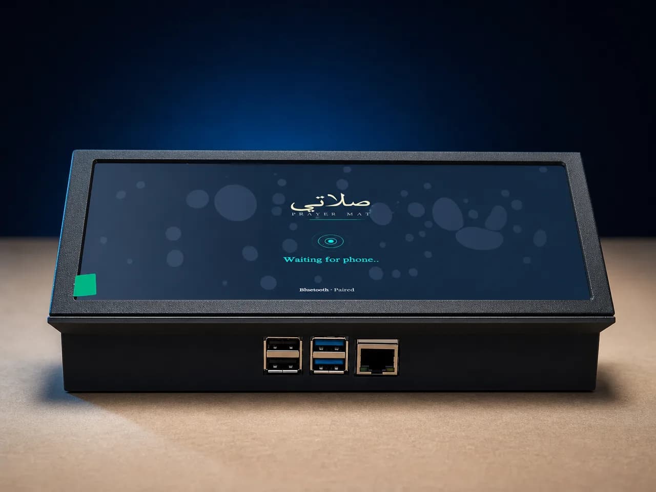 The Salati Prayer Mat prototype on a desk: a wide display in a custom black enclosure showing the Salati logo above a pairing indicator and the words “Waiting for phone…”, with USB and Ethernet ports along its front edge.